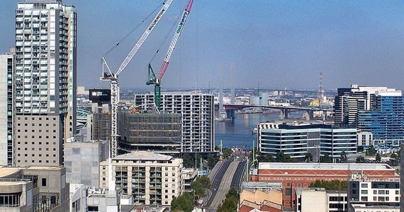 Cranes in the background of a city